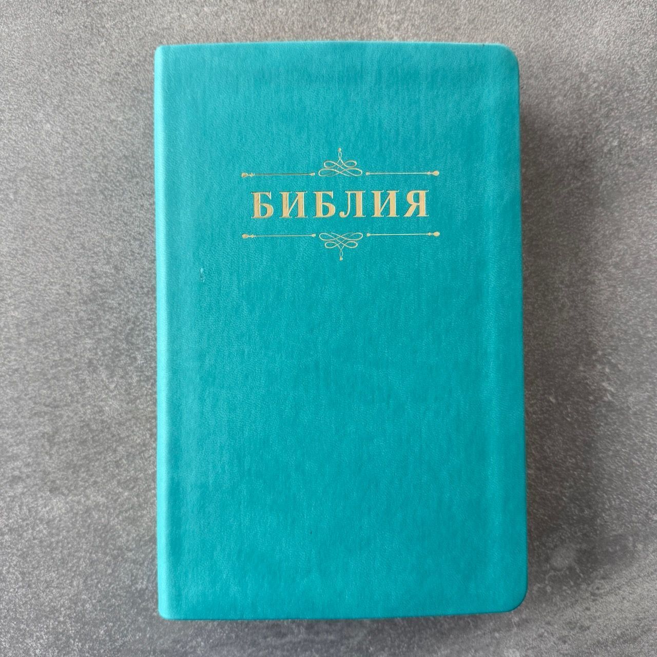 Дисконт №1 на лицевой обложке зацепка слева по центру, в верху по центру серая черточка. Библия 055 код 25055-60 дизайн "Библия с вензелем", переплет из эко кожи, цвет бирюзовый, средний формат, 143*220 мм