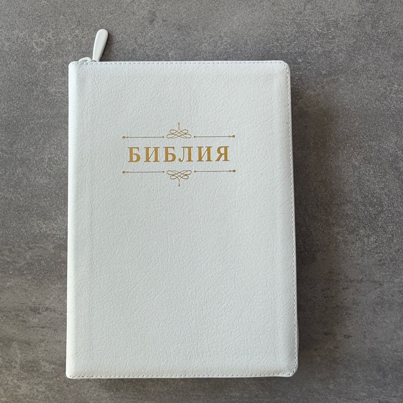 Дисконт. Бело-желтая полоска чуть выше центра спереди и сзади. Библия 076zti код 25076-16, дизайн "слово Библия", кожаный переплет на молнии с индексами, цвет белый пятнистый, размер 170x243 мм