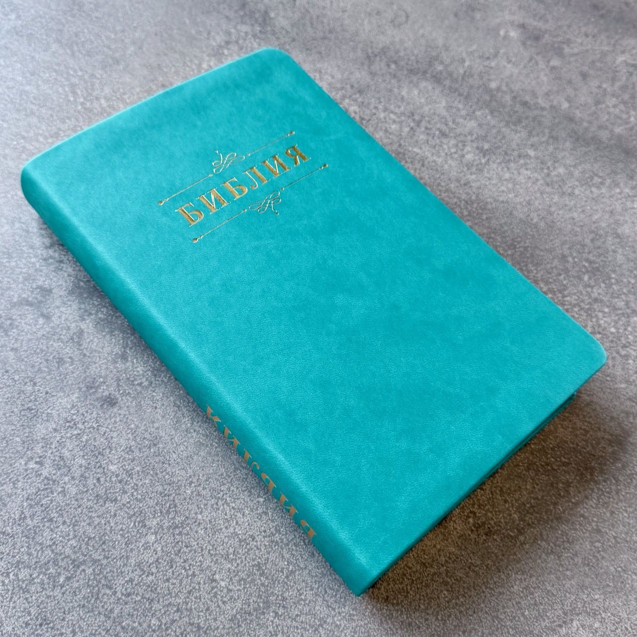  Дисконт №1 на лицевой обложке зацепка слева по центру, в верху по центру серая черточка. Библия 055 код 25055-60 дизайн "Библия с вензелем", переплет из эко кожи, цвет бирюзовый, средний формат, 143*220 мм